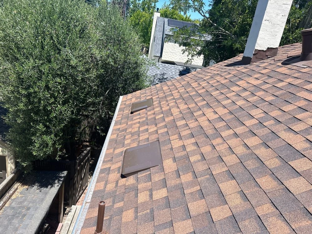 O’Hagin intake vents installed along the shingle roof to provide low-side airflow for balanced attic ventilation in Palo Alto, CA.