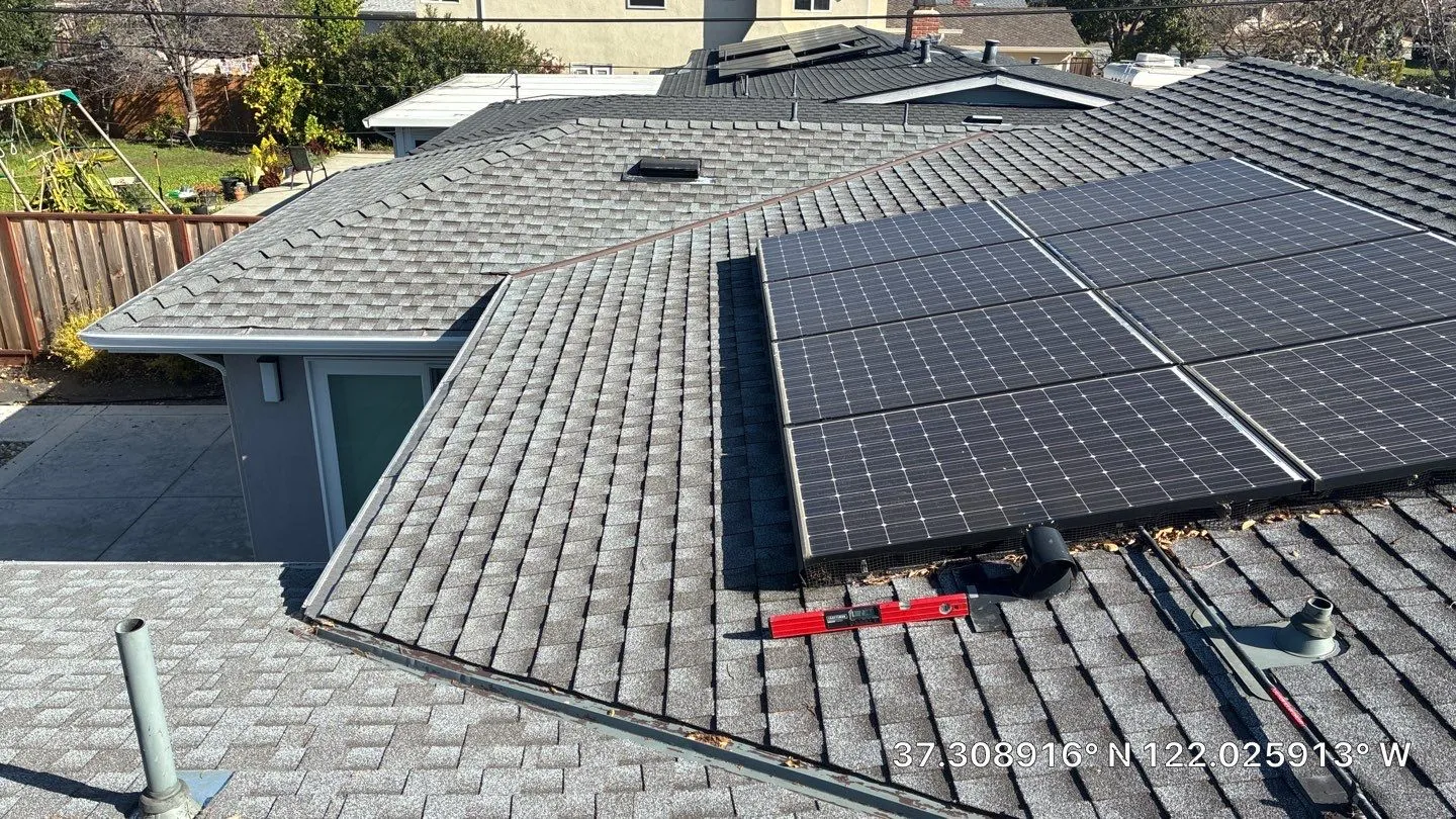Overview of an asphalt shingle roof with solar panels, roof vents, and valleys during a San Jose roof inspection.