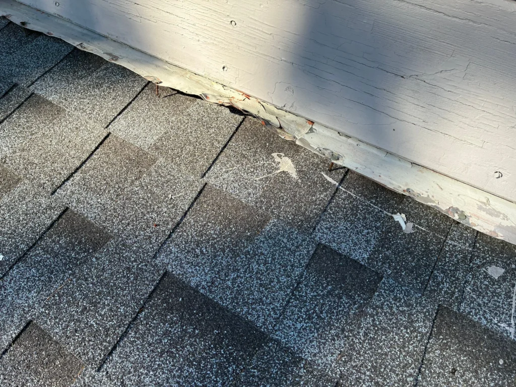 Roof exhaust vent with debris buildup around the base and flashing identified during a leak inspection.